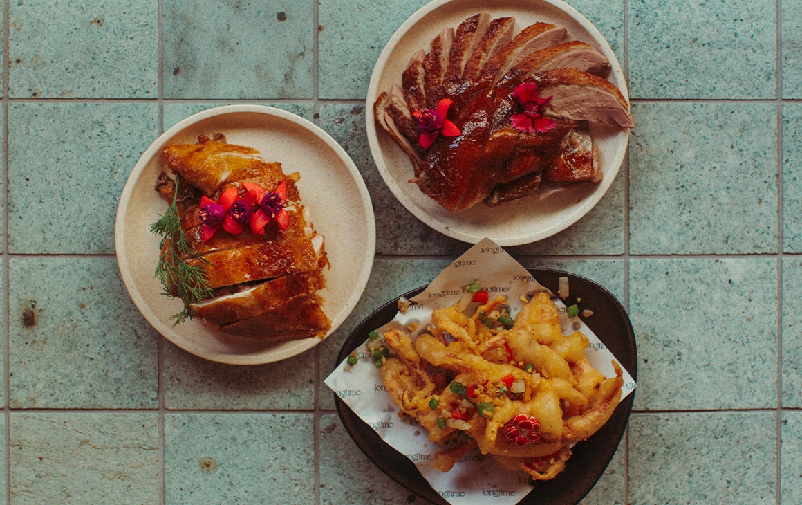 three different plates of Cantonese style food on a table, seen top down